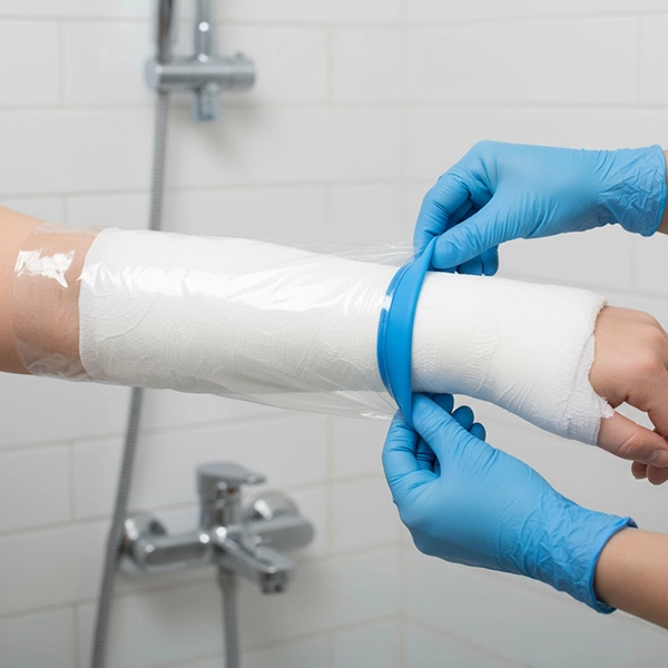 Waterproof cast cover being correctly sealed for showering, highlighting the edge seal